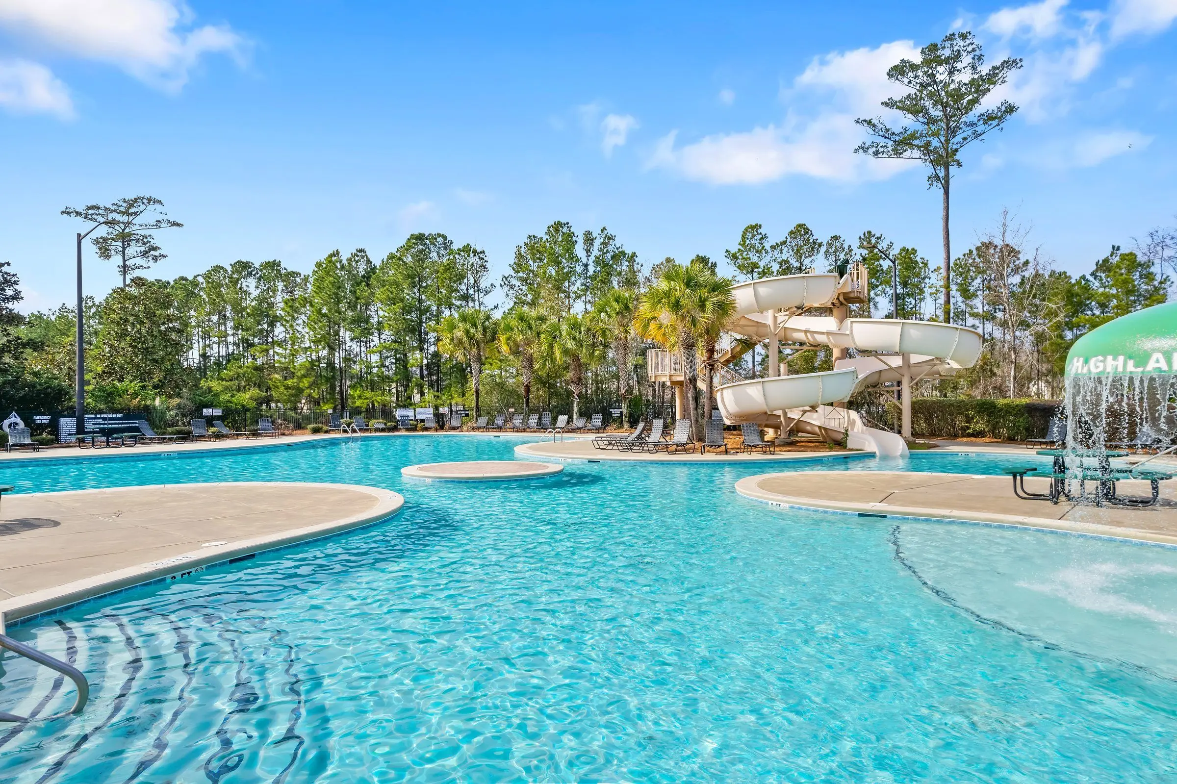 Drone view of a community resort pool with a water slide